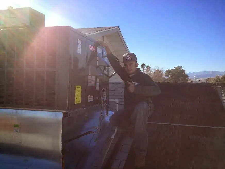 HVAC technician performing Boiler Repair on a rooftop unit in Chili